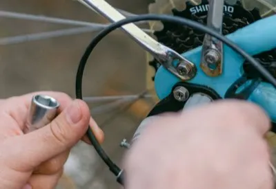 Close-up of a rear derailleur being cleaned and indexed